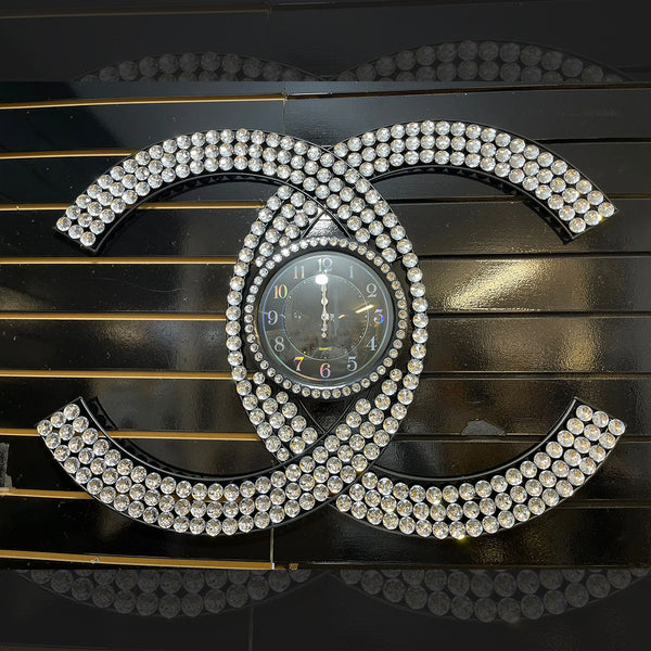 A close-up of a gold clock face with diamond-encrusted numbers and hands, surrounded by a diamond-encrusted
